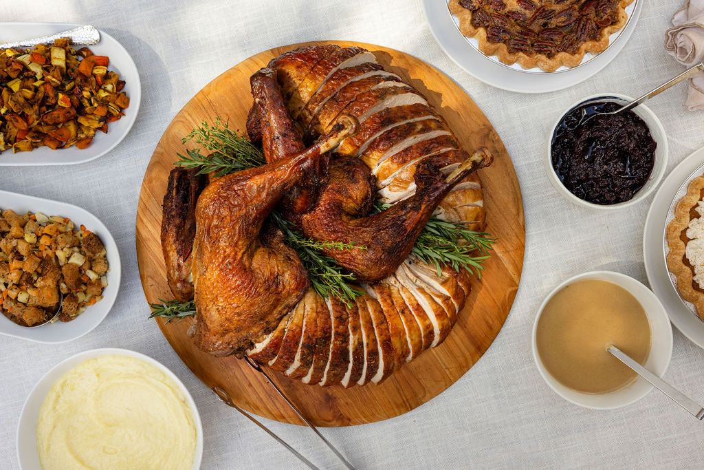 Thanksgiving dinner: carved turkey with stuffing, whipped potatoes, roasted vegetables, cranberry compote, gravy and pie